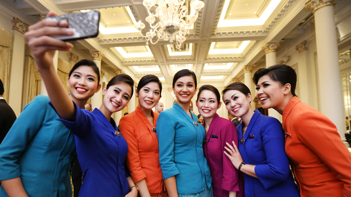 garuda indonesia crew celebrate with a group selfie